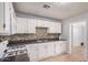 Spacious kitchen boasting white cabinetry, mosaic backsplash, and white appliances for a bright and functional space at 2750 W Turney Ave, Phoenix, AZ 85017