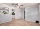 Bright living room boasting neutral walls, flooring, trim, ceiling fan, and an open entrance to the kitchen at 2750 W Turney Ave, Phoenix, AZ 85017