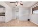 Living room features neutral walls, flooring, trim, and is open to the adjacent kitchen and other rooms at 2750 W Turney Ave, Phoenix, AZ 85017