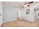 Open living room featuring neutral walls, flooring, ceiling fan, and a sunny window with space for plants at 2750 W Turney Ave, Phoenix, AZ 85017