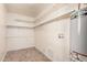 Utility room with tile flooring, shelving and a hot water heater at 2750 W Turney Ave, Phoenix, AZ 85017
