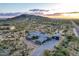 Expansive desert estate featuring a modern home, separate garage, and desert landscaping on a sprawling lot at 31226 N Granite Reef Rd, Scottsdale, AZ 85266