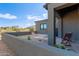 Back patio area with desert landscaping, a privacy wall, and comfortable seating overlooking the natural surroundings at 31226 N Granite Reef Rd, Scottsdale, AZ 85266