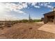 Expansive backyard featuring desert landscaping, a covered patio, and a refreshing pool amidst beautiful surroundings at 31226 N Granite Reef Rd, Scottsdale, AZ 85266