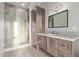 Bathroom featuring a glass enclosed shower, dark wood cabinets, white countertops, and modern lighting fixtures at 31226 N Granite Reef Rd, Scottsdale, AZ 85266