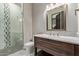 Bathroom featuring a tiled shower, dark wood cabinets, white countertops, and modern lighting fixtures at 31226 N Granite Reef Rd, Scottsdale, AZ 85266
