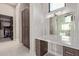 Bright bathroom featuring a vanity with large mirror and lots of storage and view to a walk-in closet at 31226 N Granite Reef Rd, Scottsdale, AZ 85266