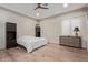 Cozy bedroom with hardwood floors, dark-wood furniture, and ample natural light from the window with shades at 31226 N Granite Reef Rd, Scottsdale, AZ 85266