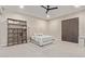 Spacious bedroom with a tufted headboard, ceiling fan, and carpeted floors at 31226 N Granite Reef Rd, Scottsdale, AZ 85266