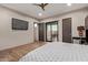 Bright bedroom with hardwood floors, modern furniture, and large sliding glass doors opening to the outdoors at 31226 N Granite Reef Rd, Scottsdale, AZ 85266