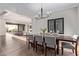 Elegant dining room with hardwood floors, contemporary chandelier, and views to the backyard at 31226 N Granite Reef Rd, Scottsdale, AZ 85266