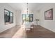 Bright dining room features hardwood floors, modern chandelier, and a large glass doors at 31226 N Granite Reef Rd, Scottsdale, AZ 85266