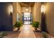 Well-lit entryway with travertine flooring, statement lighting, and view into the living room at 31226 N Granite Reef Rd, Scottsdale, AZ 85266
