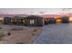Desert home at twilight featuring an extended paved driveway and minimalist desert landscaping at 31226 N Granite Reef Rd, Scottsdale, AZ 85266