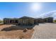 Southwestern home with a long driveway, desert landscaping, and mountain views under blue skies at 31226 N Granite Reef Rd, Scottsdale, AZ 85266