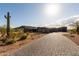 A beautiful desert home with a paved stone driveway, desert landscaping and an attached garage at 31226 N Granite Reef Rd, Scottsdale, AZ 85266