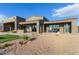 Stylish modern home with a sleek exterior design, patio area, and low-maintenance desert landscaping at 31226 N Granite Reef Rd, Scottsdale, AZ 85266