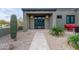 Charming front entrance featuring a tiled walkway leading to a modern doorway with a desert landscape backdrop at 31226 N Granite Reef Rd, Scottsdale, AZ 85266