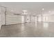 Bright and spacious garage with epoxy flooring and modern doors, offering ample parking and storage space at 31226 N Granite Reef Rd, Scottsdale, AZ 85266