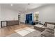 Comfortable living space off the garage, featuring a blue bookcase, keyboard, couch and utility sink with mini fridge at 31226 N Granite Reef Rd, Scottsdale, AZ 85266