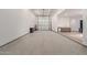 Large, finished garage with epoxy floors, wash sink, and access to the main home at 31226 N Granite Reef Rd, Scottsdale, AZ 85266