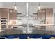 Kitchen highlights a large dark stone island with seating, stainless appliances, and open shelving at 31226 N Granite Reef Rd, Scottsdale, AZ 85266
