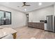 Spacious living room complete with stainless steel refrigerator, dark wood cabinets and hardwood flooring at 31226 N Granite Reef Rd, Scottsdale, AZ 85266
