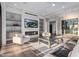 Bright living room with fireplace and large windows, creating a cozy atmosphere at 31226 N Granite Reef Rd, Scottsdale, AZ 85266