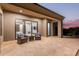 A covered patio features comfortable armchairs, stone floors, and easy indoor access at 31226 N Granite Reef Rd, Scottsdale, AZ 85266