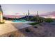 Backyard pool and spa are surrounded by desert vegetation and mountain views at sunset at 31226 N Granite Reef Rd, Scottsdale, AZ 85266