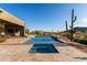 Inviting pool with travertine tile surround, plus desert views, offers a perfect escape for relaxation and leisure at 31226 N Granite Reef Rd, Scottsdale, AZ 85266