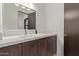 Stylish powder room with wood vanity, white countertop, modern faucet, and dark wood door at 31226 N Granite Reef Rd, Scottsdale, AZ 85266