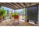 Inviting covered back patio featuring colorful rug, lounge chairs, and lovely garden views at 313 W Utopia Rd, Phoenix, AZ 85027