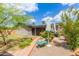 Well-manicured backyard features stone pathway, mature landscaping, and lush green lawn at 313 W Utopia Rd, Phoenix, AZ 85027