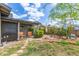 Charming backyard features a covered patio, lush garden beds, and mature landscaping at 313 W Utopia Rd, Phoenix, AZ 85027