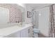 Updated bathroom with modern vanity, subway tile in shower and tub with floral wallpaper accent wall at 313 W Utopia Rd, Phoenix, AZ 85027