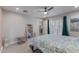 Cozy bedroom featuring a ceiling fan, light wood floors, and access to the backyard patio at 313 W Utopia Rd, Phoenix, AZ 85027