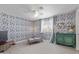 Stylish bedroom with floral wallpaper, ceiling fan, accent chair, and a vintage cabinet at 313 W Utopia Rd, Phoenix, AZ 85027