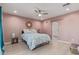 Spacious primary bedroom with a ceiling fan, hardwood floors, and a connected bathroom at 313 W Utopia Rd, Phoenix, AZ 85027