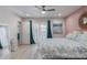 A bright bedroom with a ceiling fan, light wood floors, pastel wall paint, and backyard access at 313 W Utopia Rd, Phoenix, AZ 85027