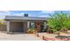 Charming single-story home with cozy front porch, attached carport, and mature desert landscaping at 313 W Utopia Rd, Phoenix, AZ 85027