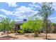 Beautiful home with manicured front garden featuring lush green foliage and decorative rocks, set in desert landscape at 313 W Utopia Rd, Phoenix, AZ 85027