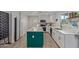 Modern kitchen features white cabinets, quartz countertops, and an island with seating at 313 W Utopia Rd, Phoenix, AZ 85027