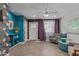 Stylish living room featuring tiled floors, vibrant wallpaper, and a ceiling fan at 313 W Utopia Rd, Phoenix, AZ 85027
