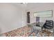 Bedroom-office featuring colorful area rug, study desk, and ample natural light at 313 W Utopia Rd, Phoenix, AZ 85027
