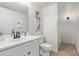 Bright bathroom with a white vanity, toilet, and a framed mirror over a sink at 3511 E Baseline Rd # 1214, Phoenix, AZ 85042