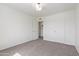 Spacious carpeted bedroom with a closet and neutral-toned walls and carpet at 3511 E Baseline Rd # 1214, Phoenix, AZ 85042