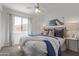 Serene bedroom with a cozy bed, soft lighting, and a view from the window at 3511 E Baseline Rd # 1214, Phoenix, AZ 85042