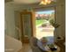 Inviting dining area with a view of the well-maintained community lawn and manicured landscaping through a glass paneled door at 3511 E Baseline Rd # 1214, Phoenix, AZ 85042
