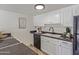 Efficient kitchen layout with modern appliances, white cabinetry, and sleek countertops at 3511 E Baseline Rd # 1214, Phoenix, AZ 85042